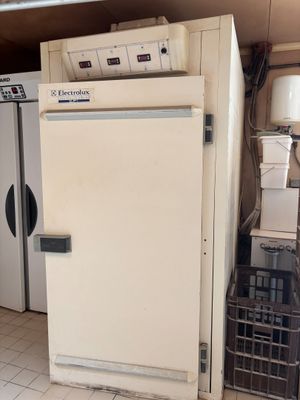 a white refrigerator and a white refrigerator freezer in a room