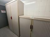 two white cupboards in a bathroom next to each other