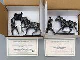 two boxed boxes with figurines of horses and riders in them