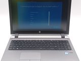 a laptop computer that is open on a white surface