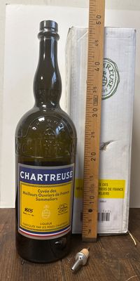 une bouteille de vin posée à côté d'une règle sur une table