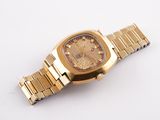 an image of a gold watch on a white surface