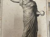an old picture of a statue of a woman holding a ball