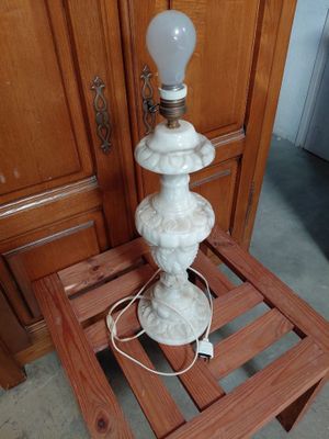 a lamp that is sitting on a small wooden table