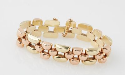 a gold bracelet with two rows of links on a white background