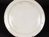 an image of a white plate sitting on top of a black table