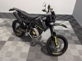 a picture of a black and yellow motorcycle parked on a checkered floor