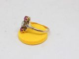 an image of a gold ring with a diamond and a ruby stone