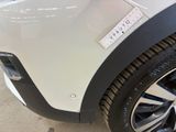 a close up of a white car with a sticker on the side of it