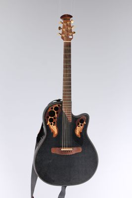 a black acoustic guitar with a wooden neck and a black case