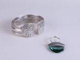 sterling silver ring with a green stone and a silver ring with a green stone
