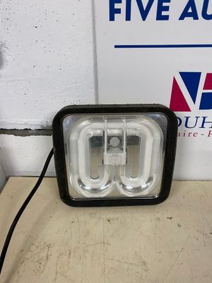 a close up of a light on a table near a sign