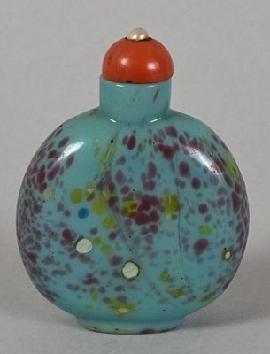a small glass bottle with a red cap on it