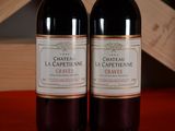 two bottles of wine sitting next to each other on a table