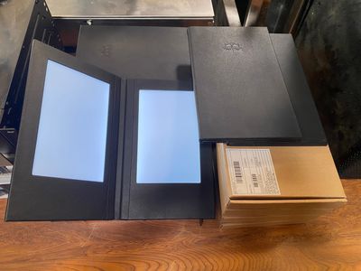 an open book sitting on top of a wooden table next to a box