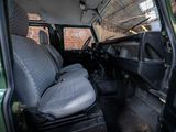 a green van with two seats in the back of it