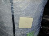 a large bag of plastic wrapped up with a sticker on it