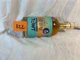 a bottle of wine on a white sheet with a price tag