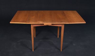 a wooden table with two leaves on the top of it