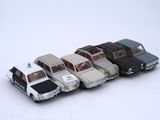 several toy cars are lined up in a row on a white surface