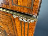 a wooden cabinet that has a metal handle on it