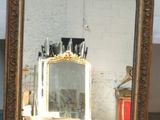 a mirror that is sitting on the floor in a room