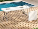 a table that is on a wooden deck near a pool