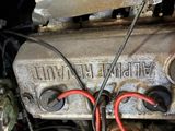 a close up of a car engine with wires attached to it