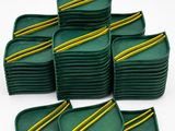 a set of six green trays with yellow stripes on them