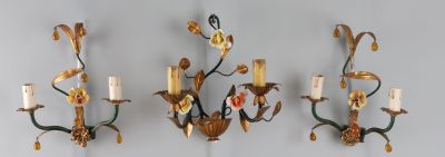 Suite de trois appliques en métal patiné et fleurette, l'une…