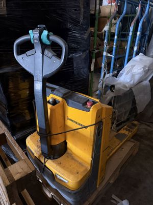 un chariot élévateur posé sur une palette dans un entrepôt
