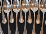 a lot of silver spoons and spoon spoons on a table