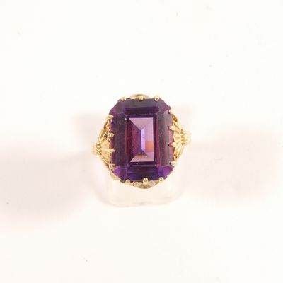 an image of a ring with a purple stone in it