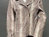 a mannequin mannequin wearing a snakeskin jacket and skirt