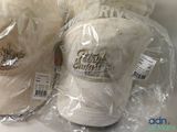 two hats that are wrapped in plastic bags on the table