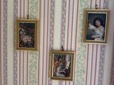 three pictures hanging on the wall above a toilet
