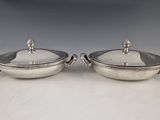 a pair of silver plated dishes with handles and handles