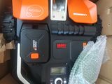 an orange and black electric chainsaw sitting in a cardboard box