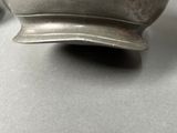a silver bowl sitting on a table next to a pair of scissors
