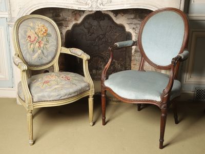 two chairs sitting next to each other in front of a fireplace