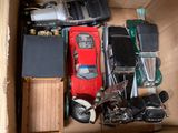 a box full of assorted toy cars and electronic devices