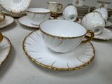 a lot of cups and saucers sitting on a table
