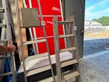 un homme qui se tient à côté d'une échelle