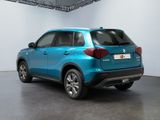 the rear end of a blue suv parked in a garage