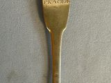 a spoon that has a gold colored handle on it