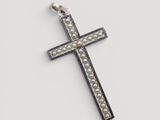 a close up of a cross on a white surface
