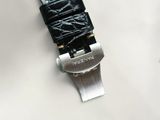 a close up of a watch on a white surface with a black strap