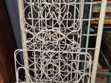 an old white iron gate with a decorative design on it