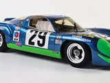 blue and green model of a racing car on a white surface