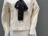 an image of a mannequin wearing a white shirt with a black tie
